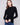 Black ribbed knit sweater featuring a stylish mock neck design by Charlie B.
