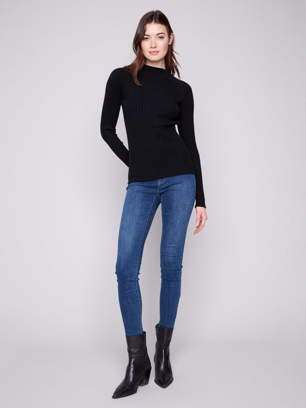 Chic black knit sweater highlighting long sleeves and modern style by Charlie B.