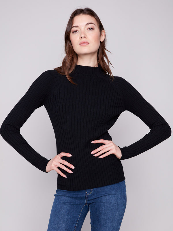Trendy black ribbed knit sweater showcasing its elegant long sleeves by Charlie B.