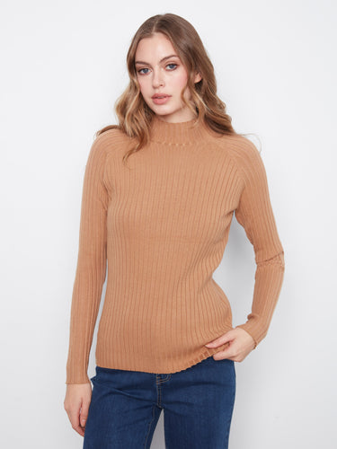 This long sleeve beauty is crafted to provide warmth without sacrificing style, perfect for any season by Charlie B.
