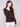 Classic mocha sweater designed with a sophisticated V-neck, ribbed detail, and eye-catching heart rivet accents by Charlie B.