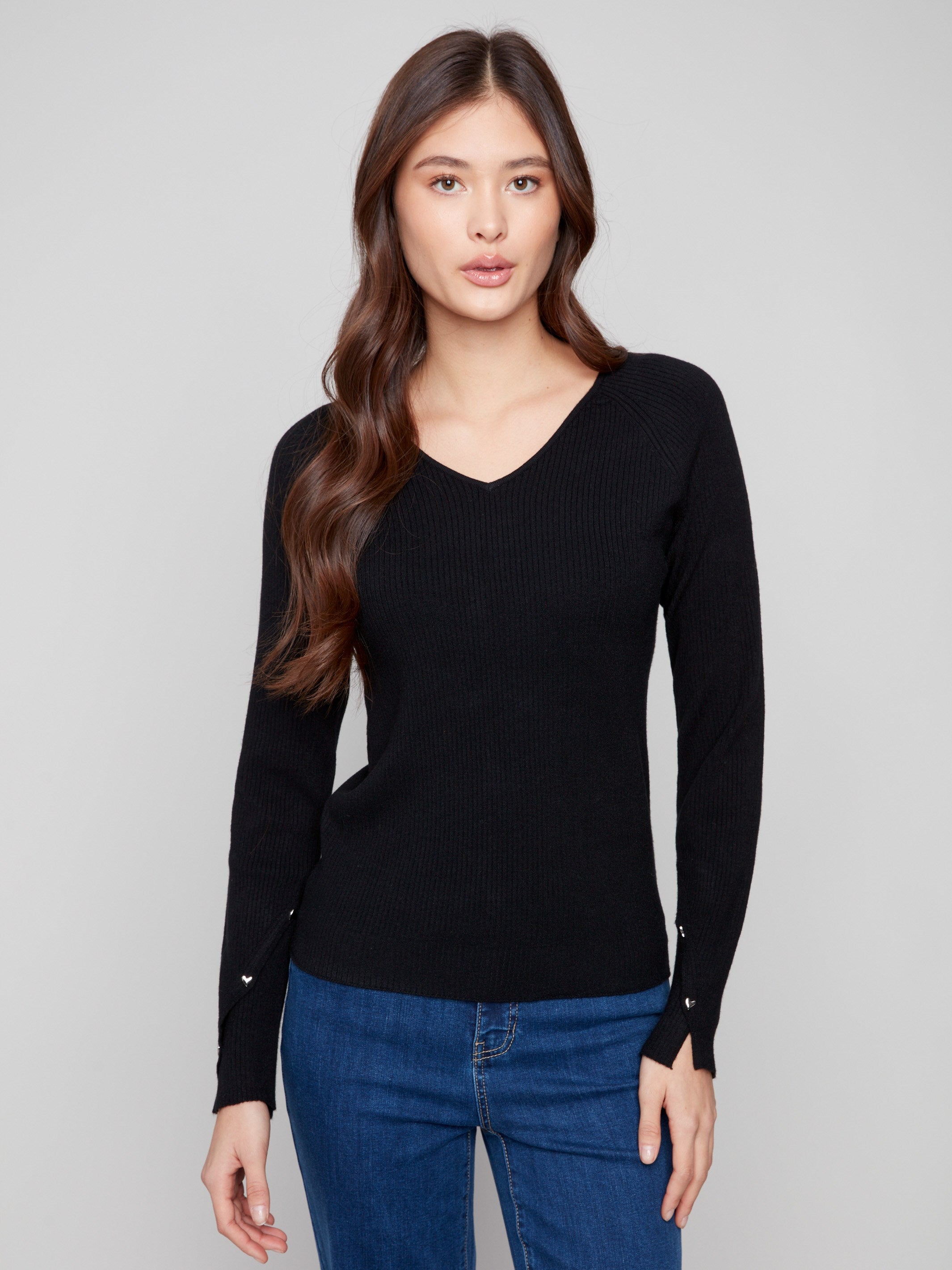 Black ribbed sweater featuring a slim fit design, perfect for a sleek silhouette by Charlie B.