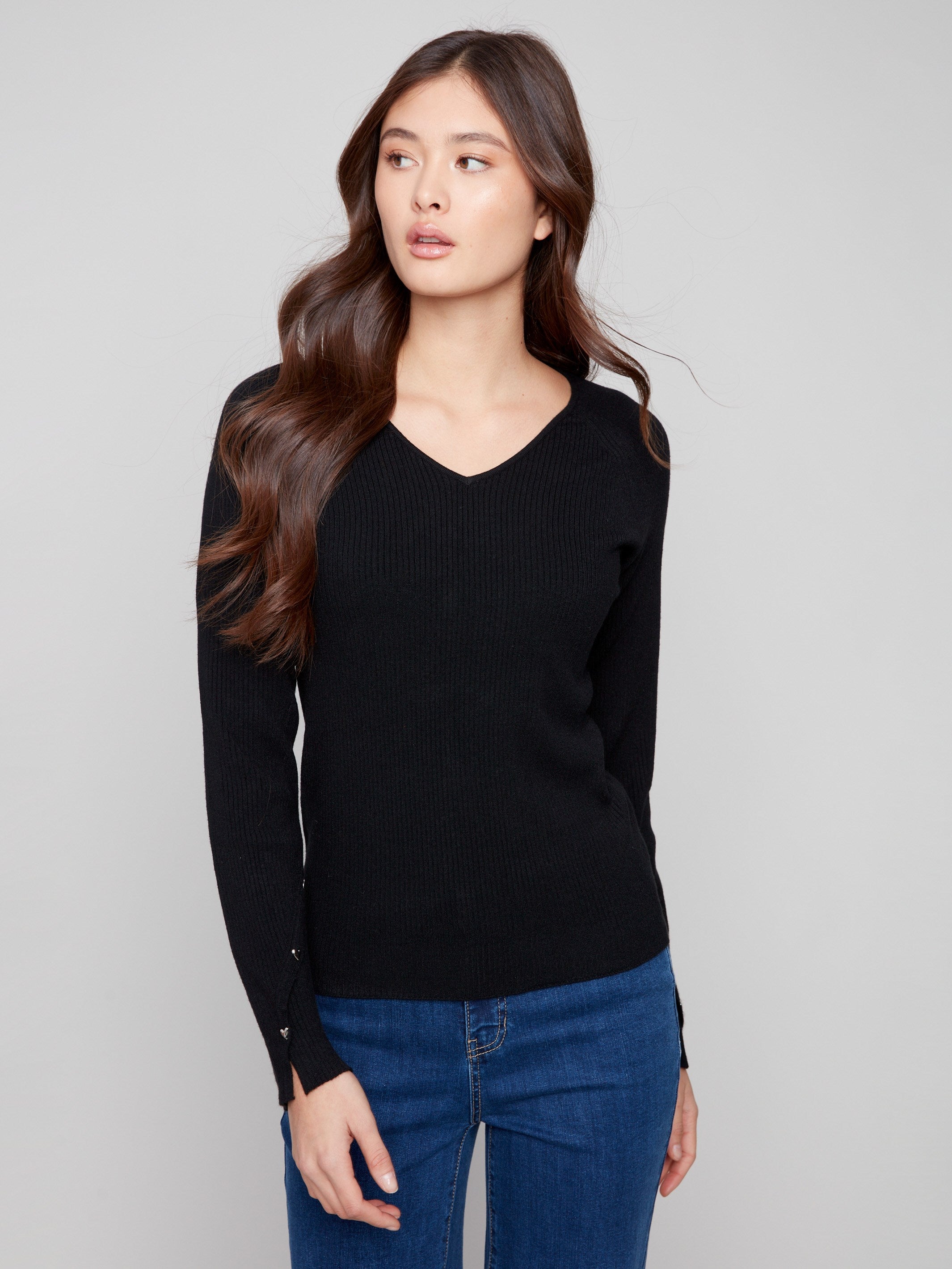 Chic V-neck black sweater with ribbed texture, offering both style and comfort by Charlie B.
