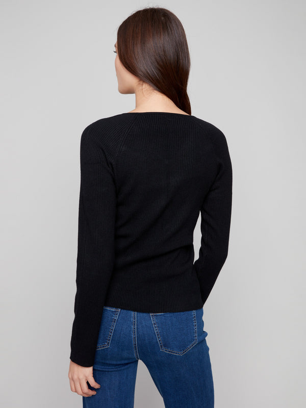 Sophisticated black sweater showcasing a flattering slim fit and timeless design by Charlie B.