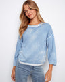 This blue top features a classic crew neckline, perfect for casual outings. Made from 100% cotton for ultimate comfort by Charlie B.