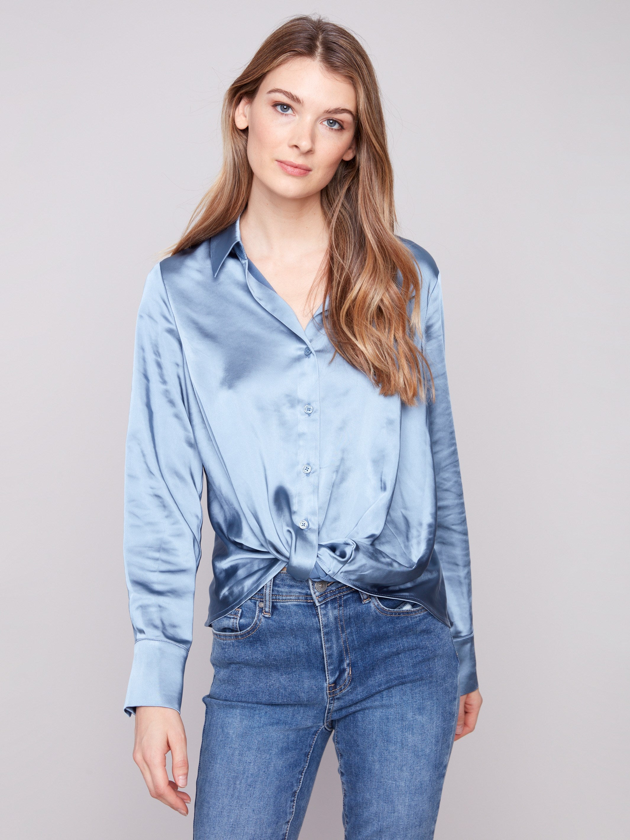 Blue satin shirt with long sleeves and a soft, luxurious fabric, featuring a twisted front detail by Charlie B.