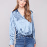 Blue satin shirt with long sleeves and a soft, luxurious fabric, featuring a twisted front detail by Charlie B.