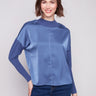 Satin-knit top with a mock neck and ribbed cuffs, showcasing drop shoulders for a relaxed fit by Charlie B.