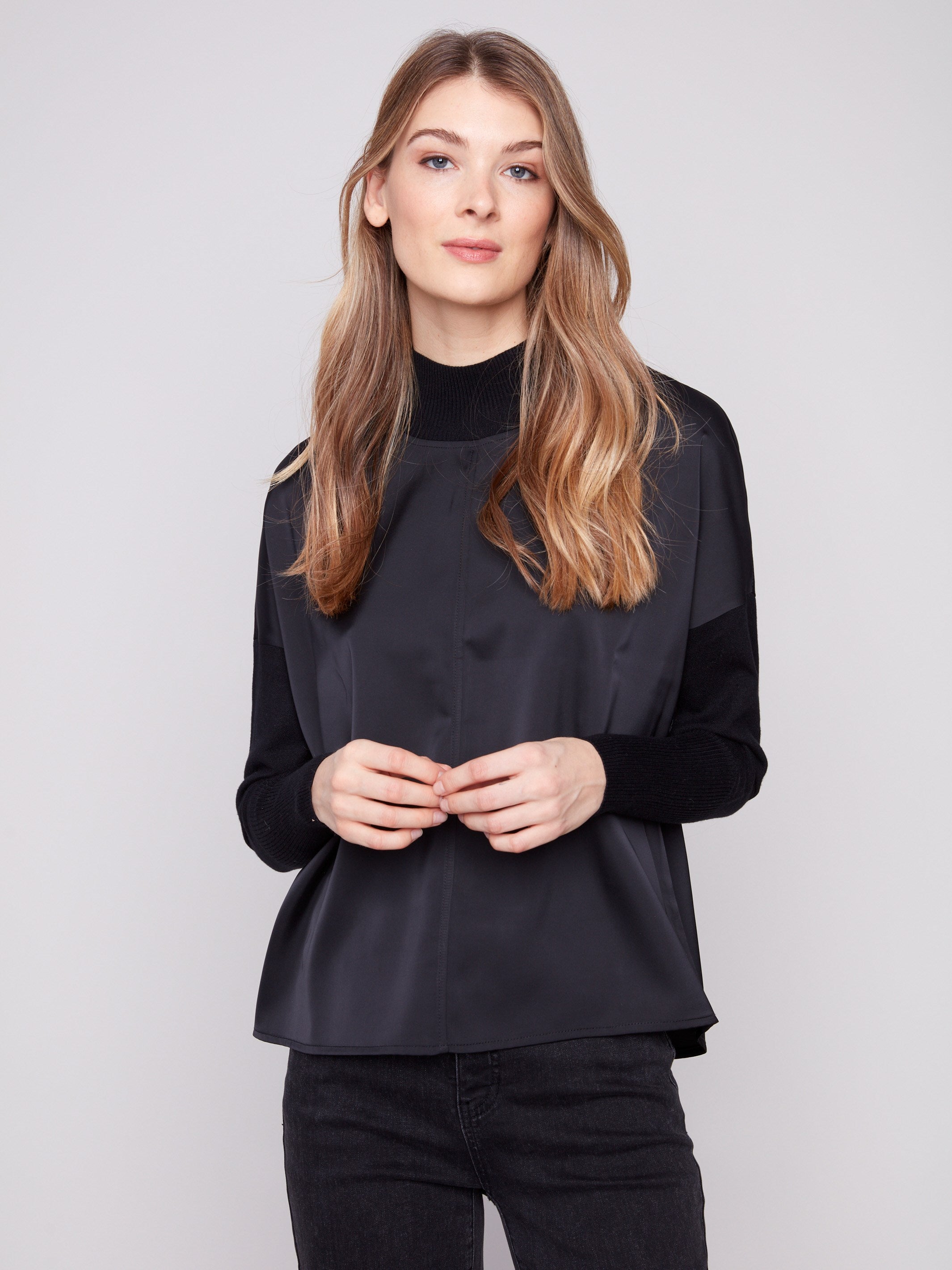 Chic black top showcasing drop shoulders and an elegant design that complements any style by Charlie B.
