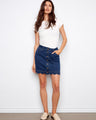 Indigo denim skort with a short length and stylish button-front, featuring built-in shorts for comfort by Charlie B.