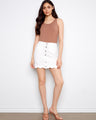 White skort featuring a chic scalloped hem and convenient front pockets, made from stretch twill fabric by Charlie B.