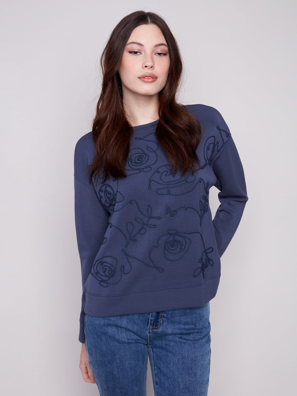 Moonlight Scuba Knit Top showcasing its elegant crew neckline, paired with long sleeves for a stylish look by Charlie B.