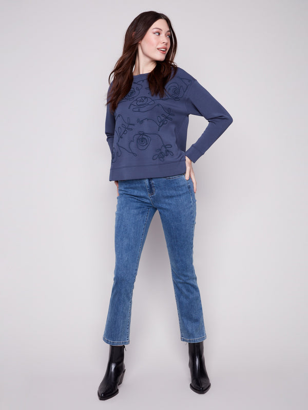 Soutache front detail adds a touch of sophistication to the Moonlight Scuba Knit Top, enhancing its unique style by Charlie B.