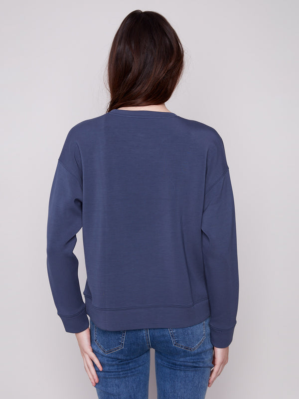 Long sleeves provide comfort and warmth in this Moonlight Scuba Knit Top, perfect for cooler days by Charlie B.