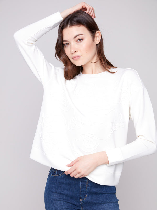 Stylish top with long sleeves and elegant soutache details, offering comfort and sophistication by Charlie B.