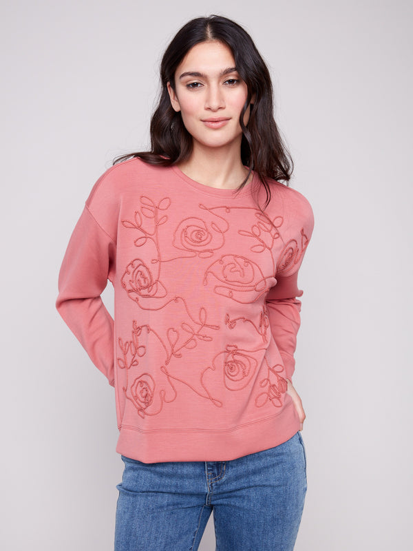 Adorned with exquisite soutache front detail, the Primrose Scuba Knit Top offers a unique fashion statement by Charlie B.