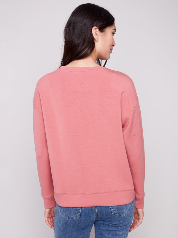 The Primrose Scuba Knit Top showcases timeless simplicity and elegance in its back view design by Charlie B.