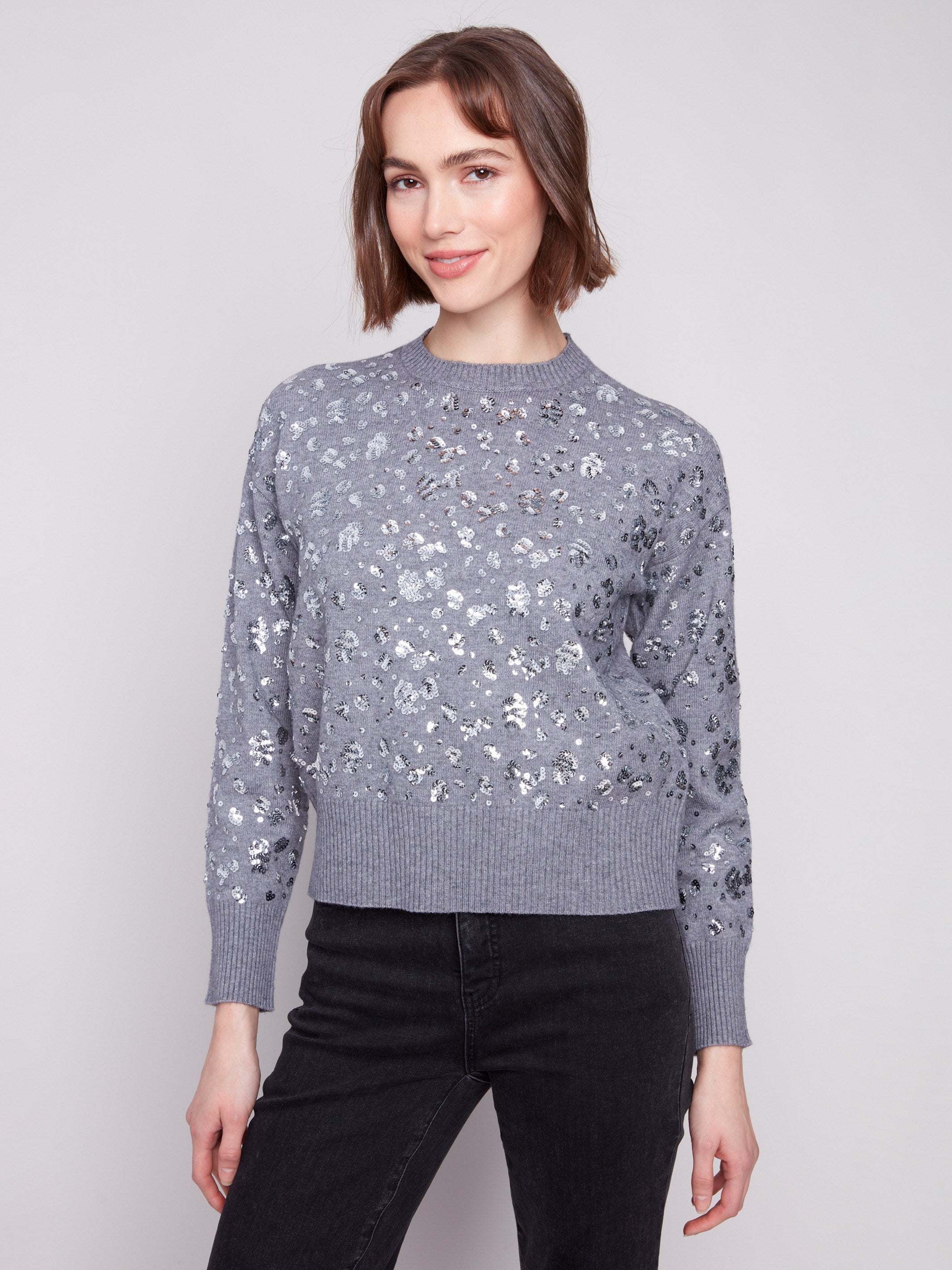 Elegant sweater in dark heather grey showcasing intricate sequins pattern by Charlie B.