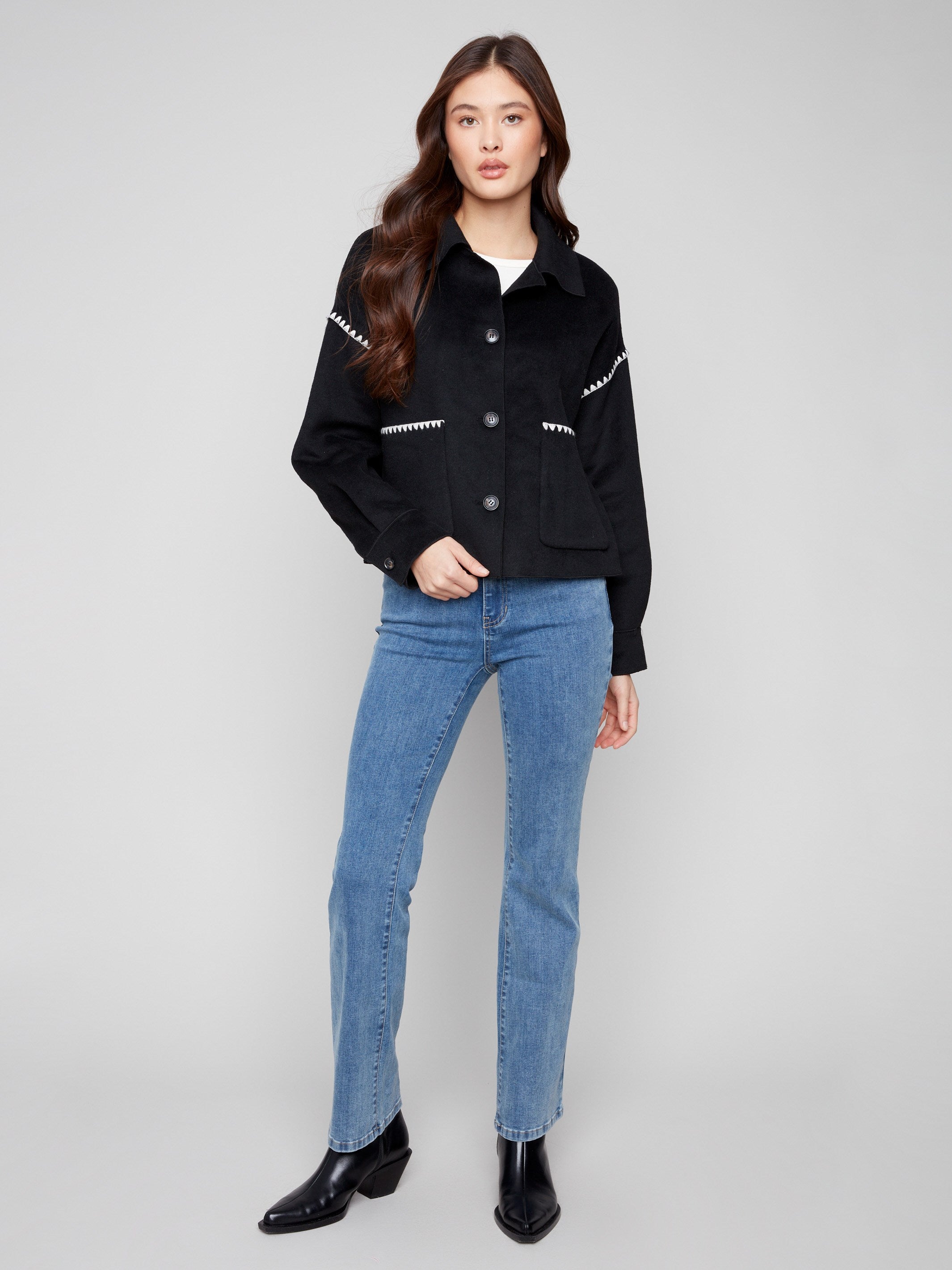 Stylish black jacket with a button front closure and elegant patch pockets, combining function with fashion by Charlie B.