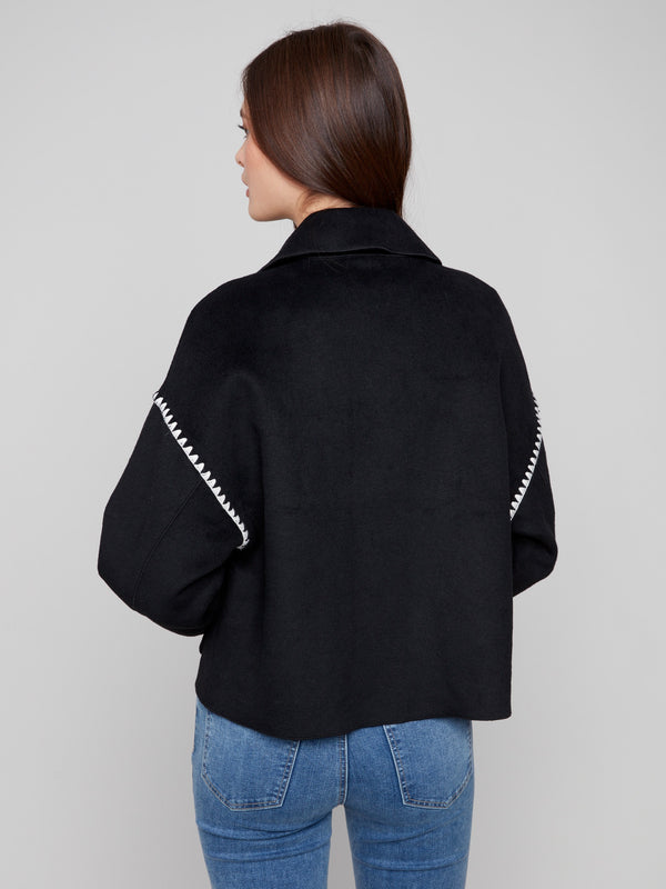 Elegant black wool jacket highlighted by intricate blanket stitch detailing for a unique touch by Charlie B.