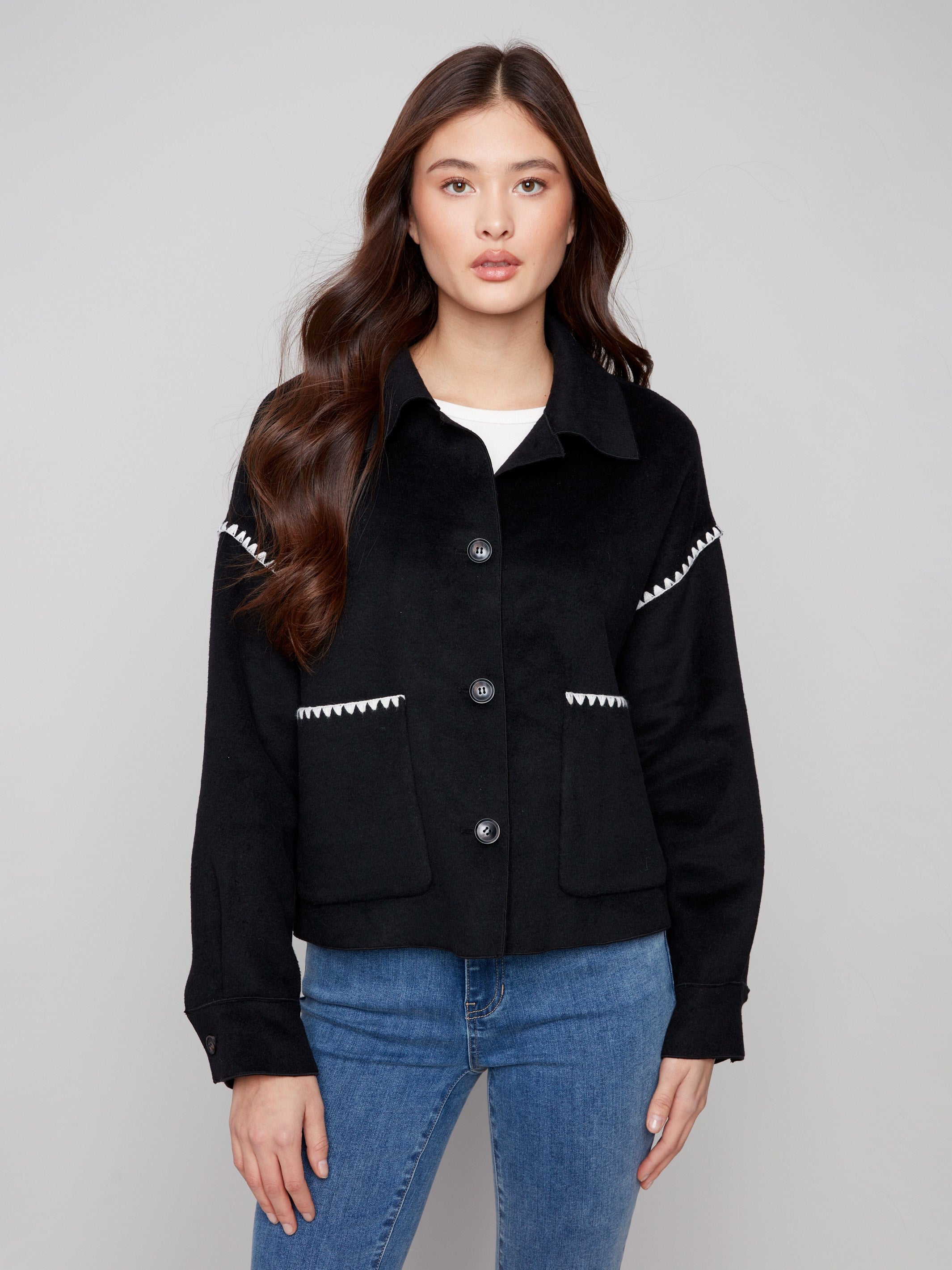 Chic black double-face wool jacket showcasing sophisticated design elements like button cuffs by Charlie B.