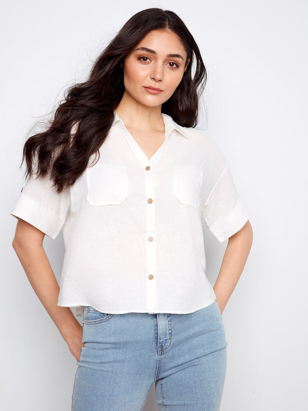 Chic white shirt with short sleeves and button tabs, offering a relaxed yet polished look. A versatile piece by Charlie B.