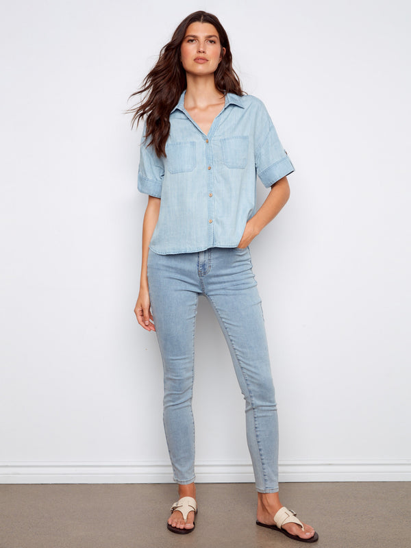 Chic light blue blouse featuring a shirt collar and button-front design, perfect for casual outings by Charlie B.
