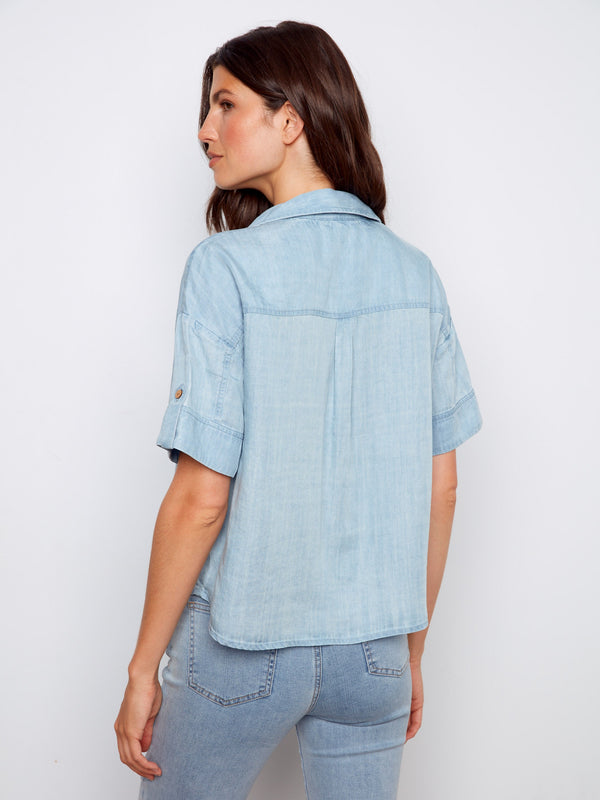 Stylish light blue blouse with comfortable short sleeves and elegant chest pockets by Charlie B.