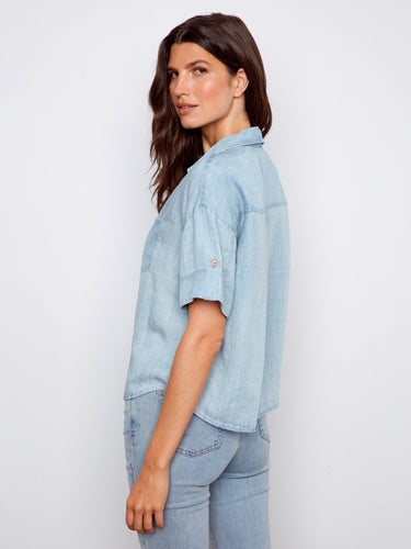 Trendy light blue Tencel blouse showcasing a classic shirt collar and versatile design by Charlie B.