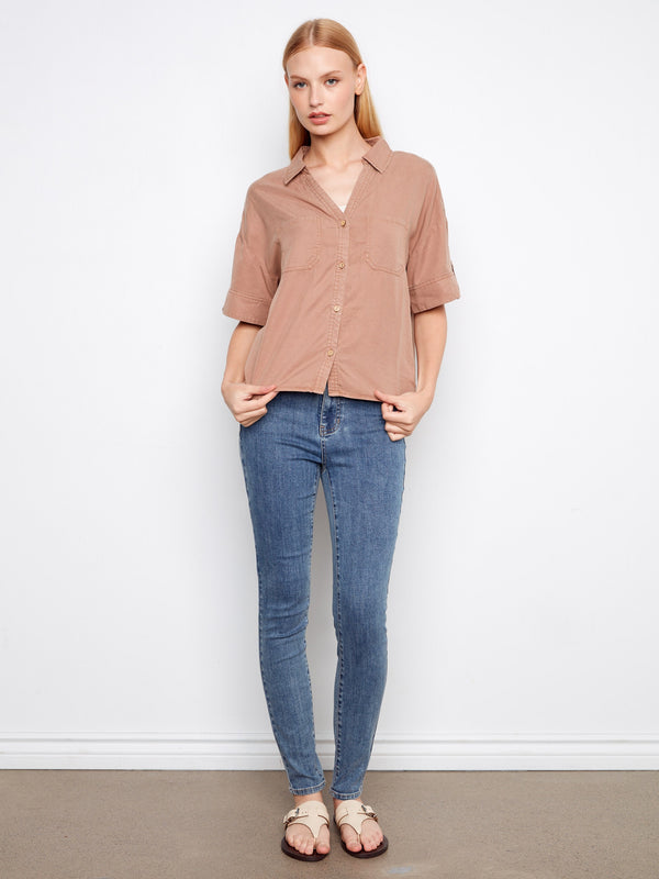 Featuring short sleeves with button tabs, this shirt combines comfort and modern fashion effortlessly by Charlie B.