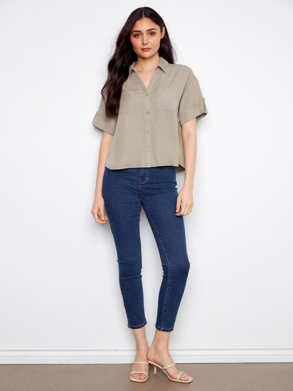 This chic shirt showcases a button-front design, perfect for casual or formal occasions. By Charlie B.