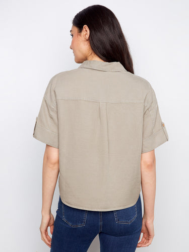 Designed with short sleeves and button tabs, this shirt offers comfort and style in one package. By Charlie B.