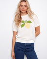 White cotton sweater with a lemon design, featuring a classic crew neckline for a timeless look. By Charlie B.