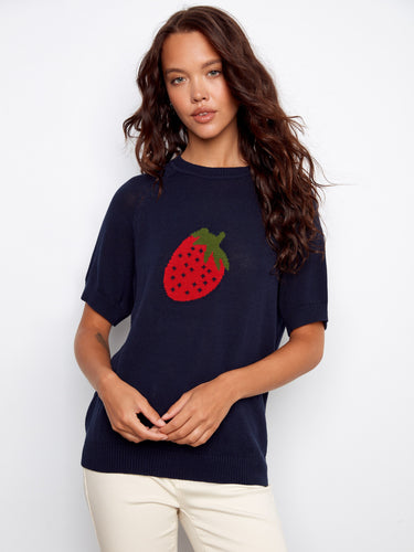 Stylish navy top adorned with a vibrant strawberry motif, crafted from soft cotton and raglan short sleeves. By Charlie B.