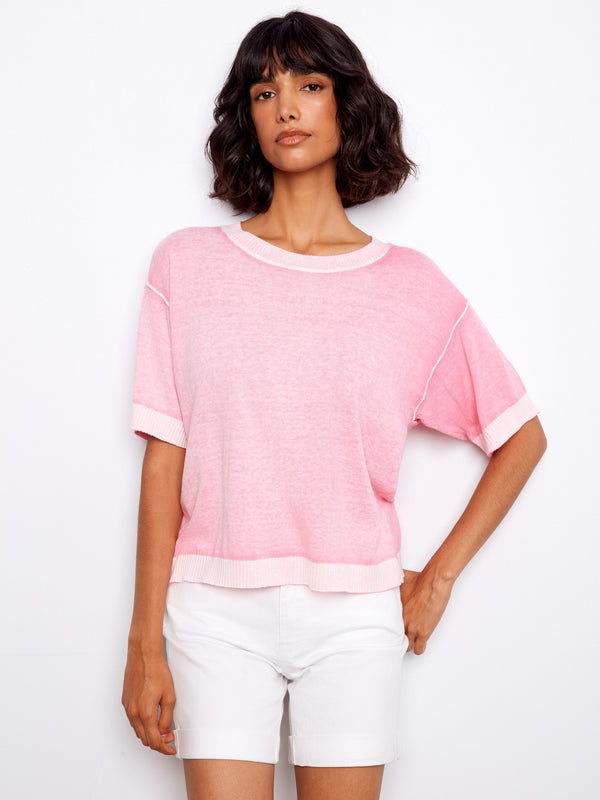 Pink top with a classic crew neck, offering a versatile style for any occasion. Made from soft fabric for comfort by Charlie B.