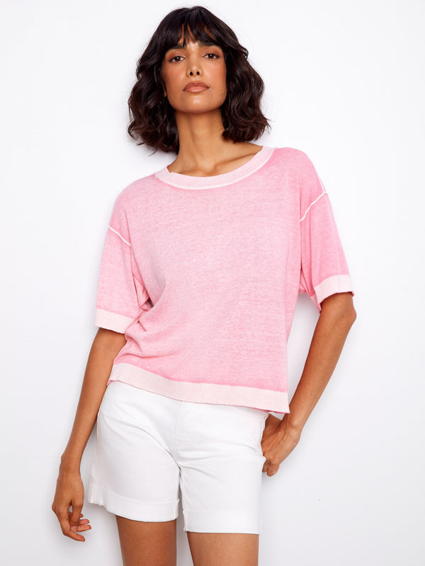 This stylish pink t-shirt combines comfort and fashion effortlessly, making it a must-have staple in your closet by Charlie B.