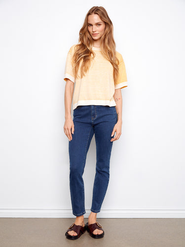 Chic yellow top featuring a reverse print design, offering a unique style perfect for casual outings. Made by Charlie B.
