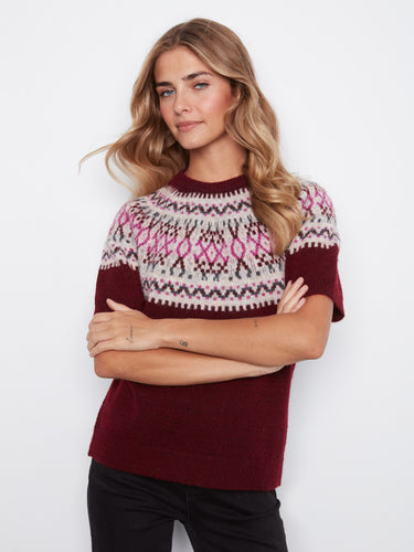 This sweater features a crew neckline and showcases a charming geometric pattern with pink accents. By Charlie B.