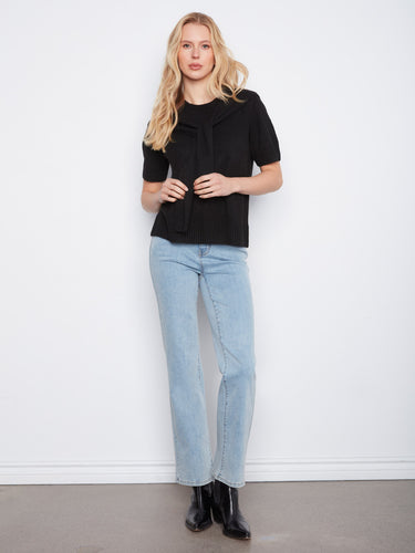 Black sweater featuring a crew neckline and stylish design by Charlie B.