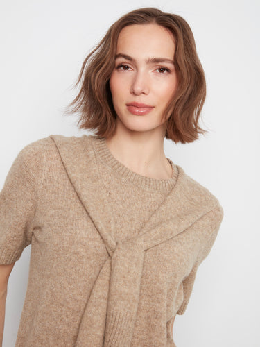 Crafted from soft knit fabric, this piece offers comfort and style in one elegant package. By Charlie B.