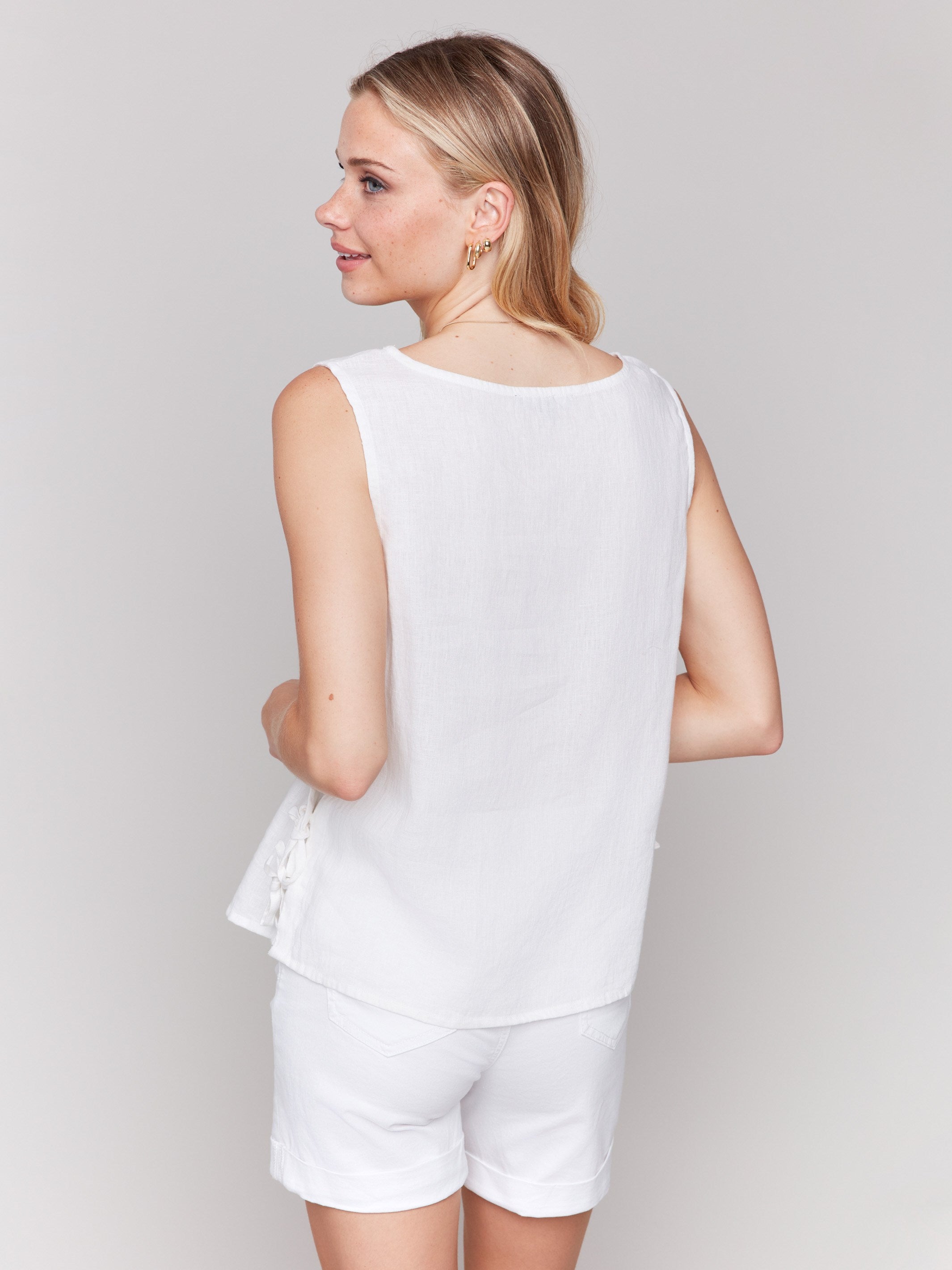 Sleeveless white top in a comfortable linen blend, perfect for layering by Charlie B.