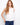 White linen top featuring a high-low hem and side button detailing for a chic look by Charlie B.
