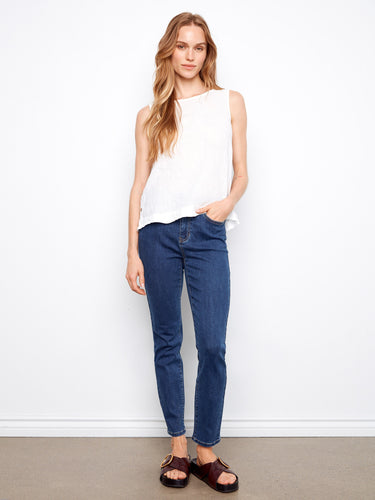 Experience comfort with the sleeveless cut of this stylish white linen top by Charlie B.