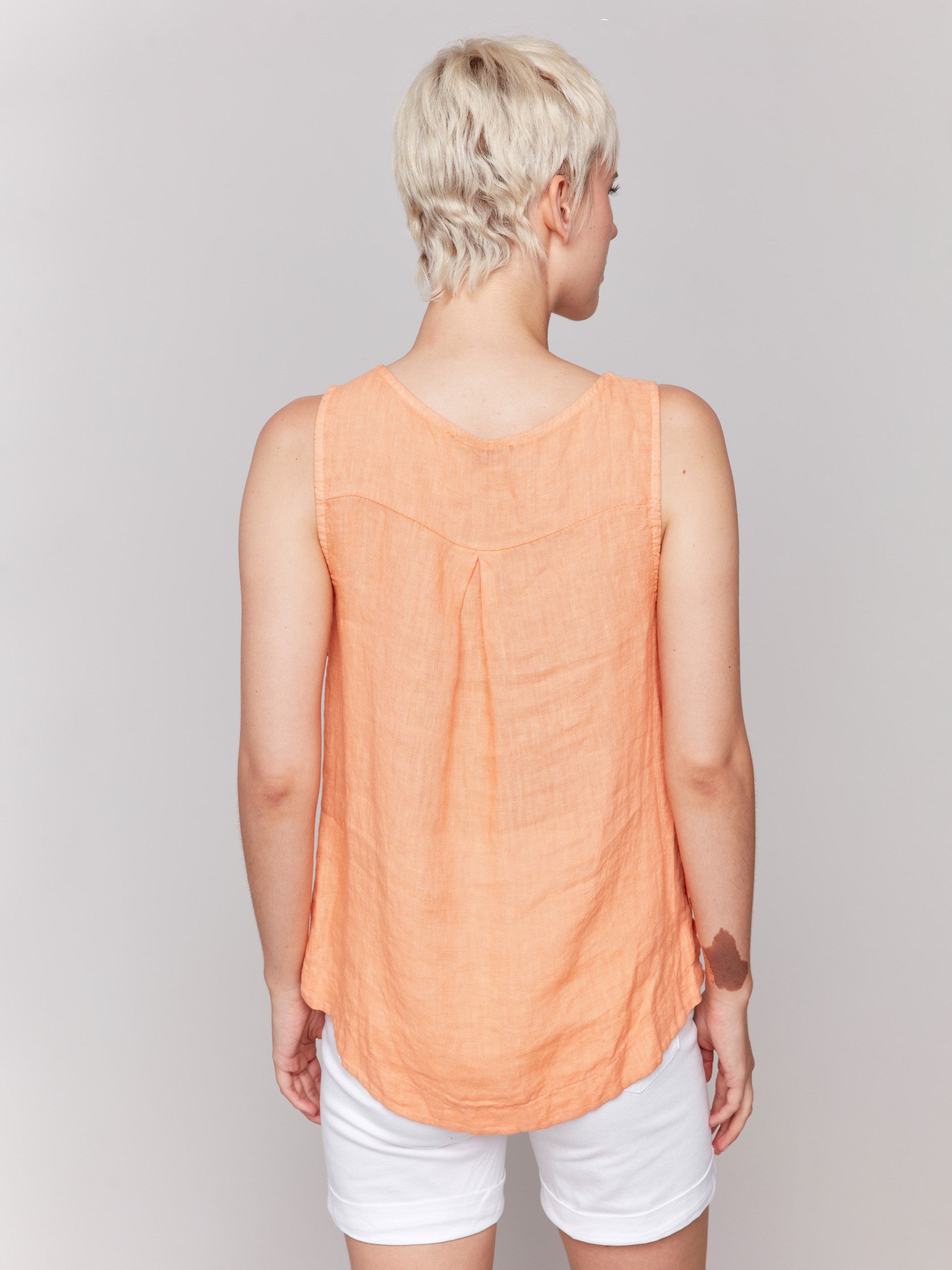 Elegant sleeveless design on this papaya linen top by Charlie B.