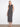 Black sleeveless striped scuba dress featuring a maxi length for elegant style by Charlie B.