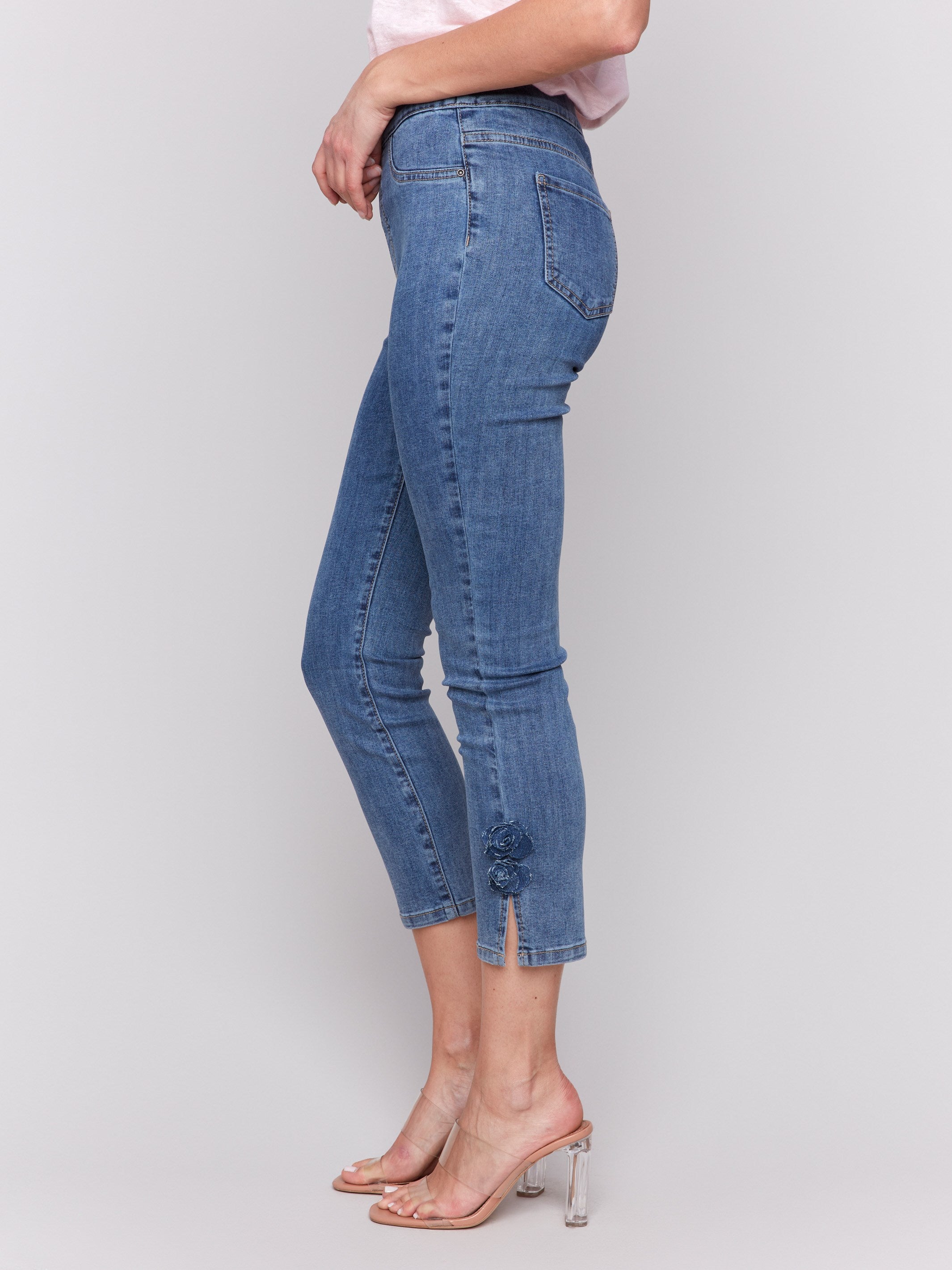 Pull-on style medium blue jeans featuring slim fit design by Charlie B.