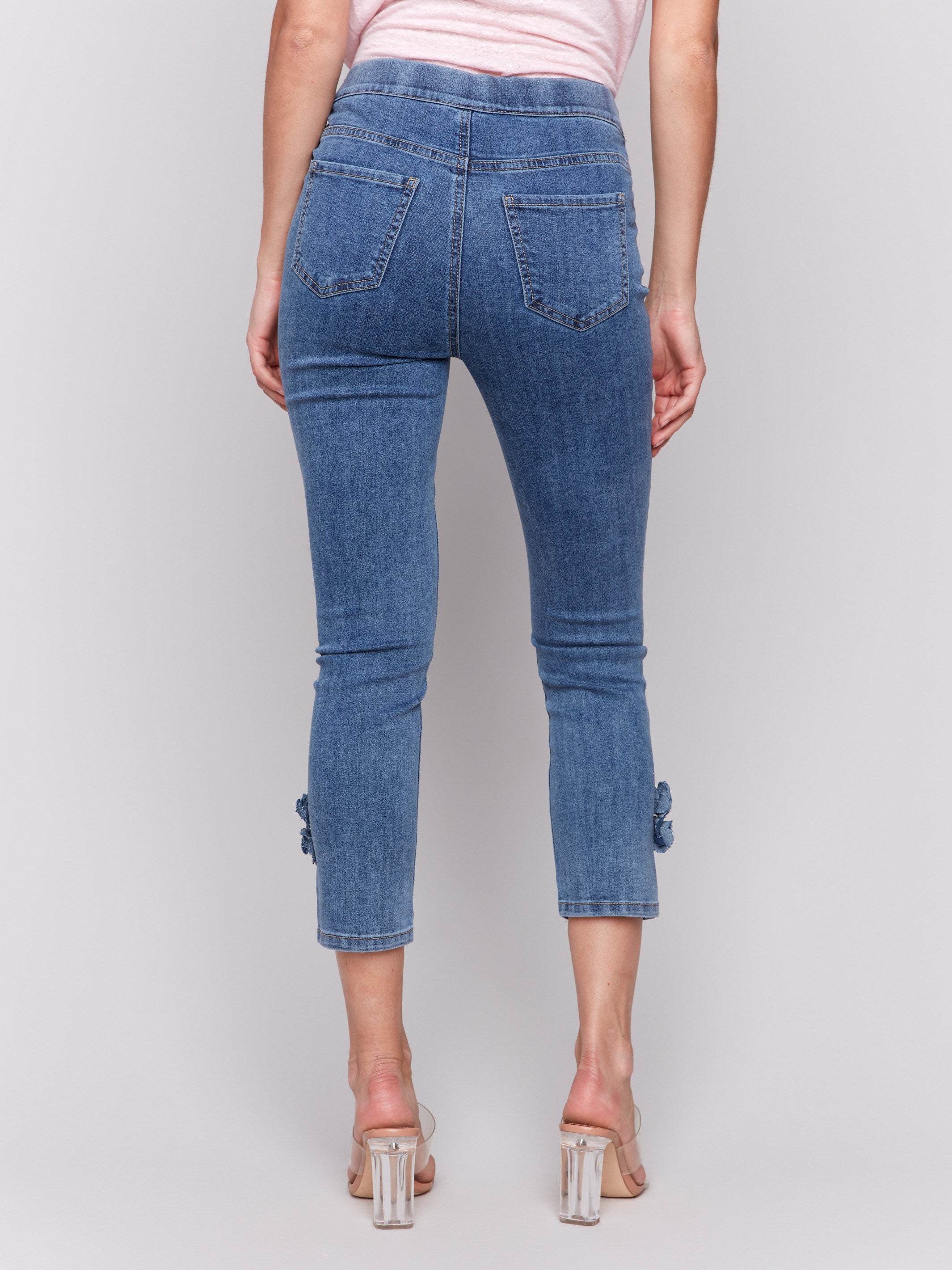 Stretch denim fabric in medium blue with floral side details by Charlie B.