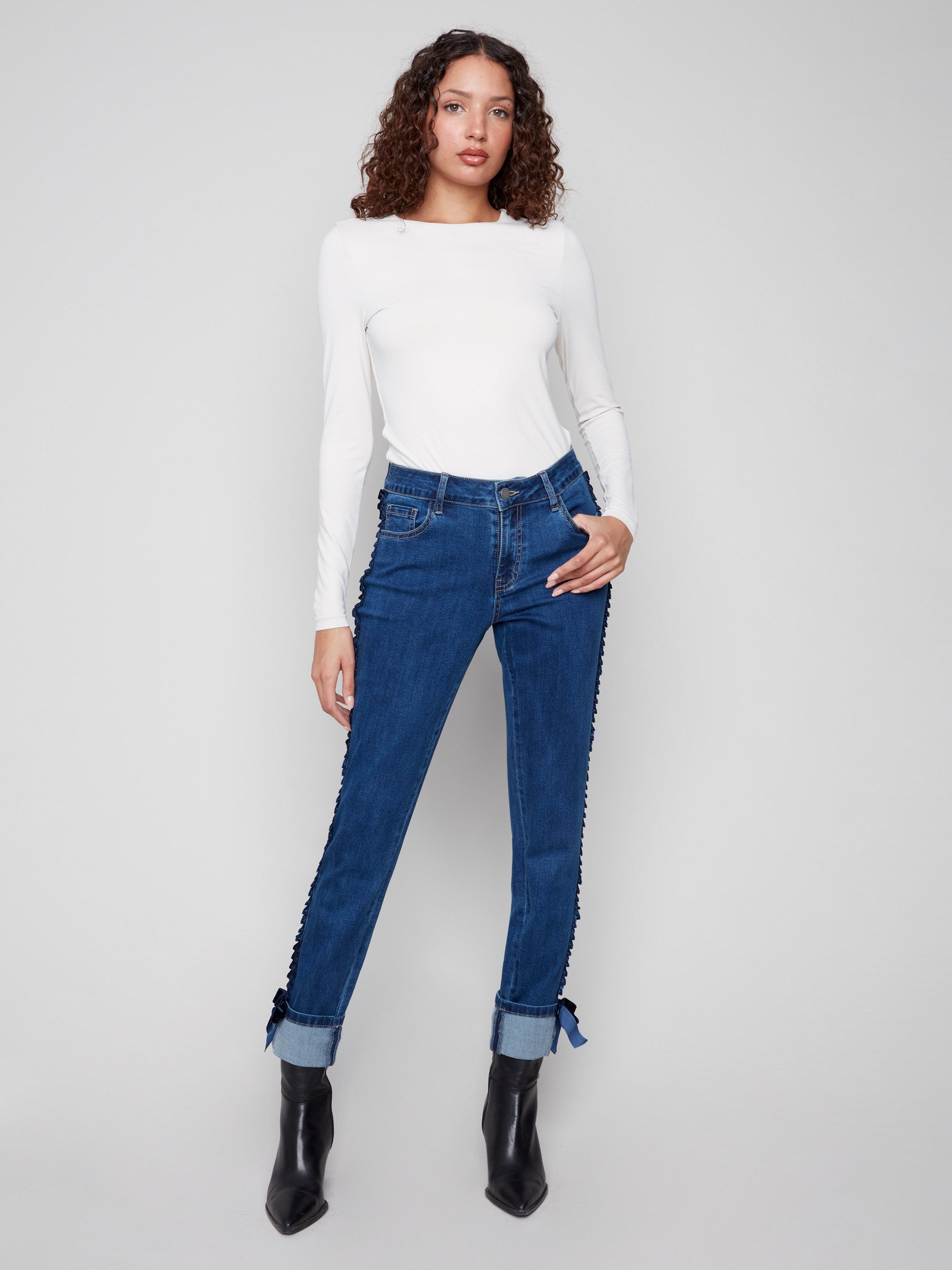 Indigo jeans in stretch denim with a slim fit and stylish velvet bow trim, perfect for any occasion by Charlie B.