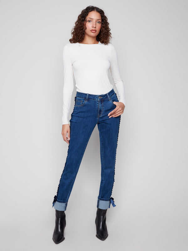Indigo jeans in stretch denim with a slim fit and stylish velvet bow trim, perfect for any occasion by Charlie B.