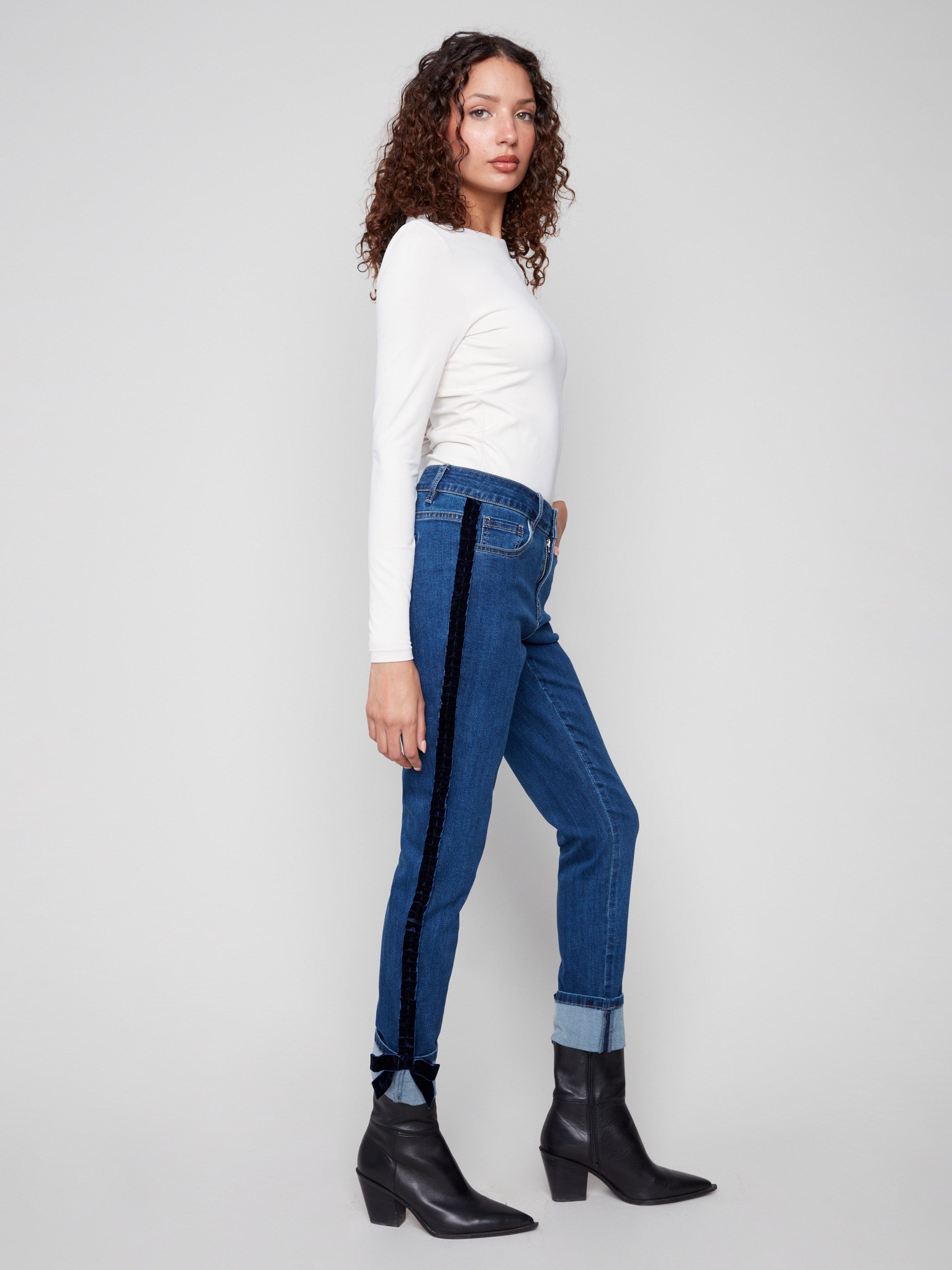 These indigo jeans feature a five-pocket design and ankle-length style, making them versatile for day or night by Charlie B.